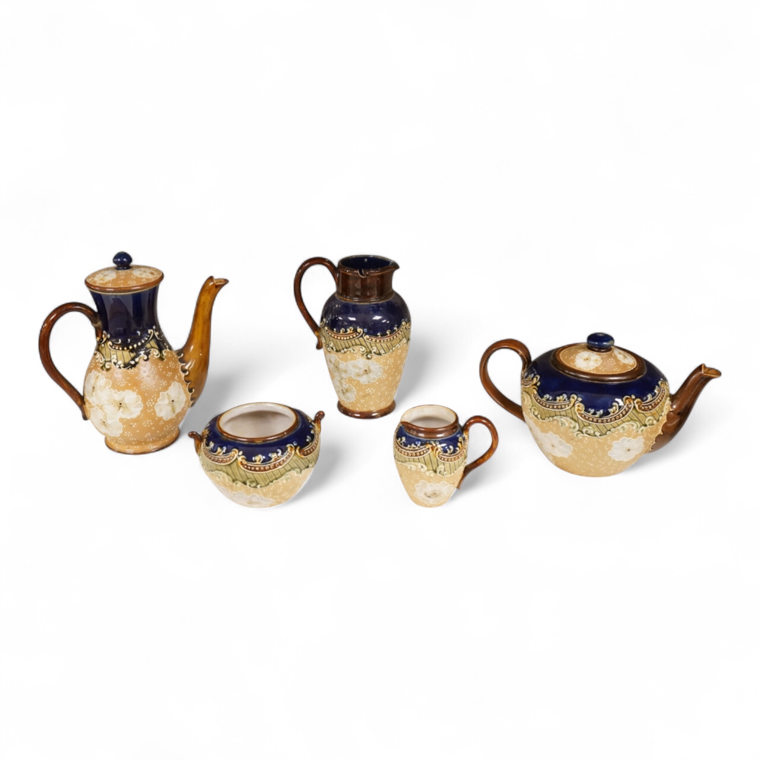 A small collection of Doulton Lambeth stoneware comprising, tea and coffee pots, two jugs and sugar bowl, largest 21cm high